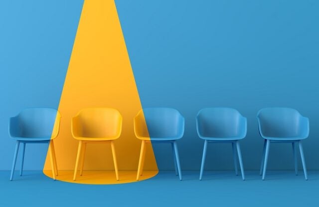 Yellow chair standing out from the crowd. Business concept. 3D rendering